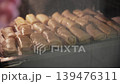Checking the Readiness of Meat Crepe Rolls Inside a Hot Oven 139476311
