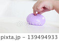 Hand holding purple dumpling stress squishy toy 139494933