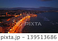 Illuminated Beach Promenade At Night, Aerial View Of Gentle Surf And Glowing Streetlights Lining Golden Sand, 139513686