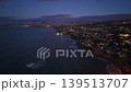Evening Coastal Town With Twinkling Lights. Cinematic Twilight Drone Shot Of Residential Shoreline, Calm Surf, 139513707