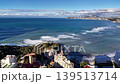 Rolling Surf Breaking Along Rocky Coastline, White Foam Lines And Strong Ocean Swells, Cliffside Buildings 139513714