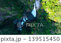 A breathtaking 4K drone aerial video captures the stunning view of Fudo Nanaju Falls, one of Japan's Top 100 Waterfalls, in Shimokitayama Village, Nara Prefecture, as it approaches and recedes from a bird's-eye perspective. 139515450