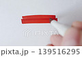 Red marker strokes and hatching cloud with real marker for text overlay on textured white paper 139516295
