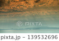 Unusual clouds spread across the sea of a remote island at dusk. 139532696