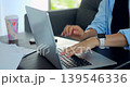Professional engaged in reviewing reports at desk. Serene scene of employee working diligently at home. Peaceful remote workspace where worker examines papers and records notes attentively 139546336