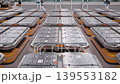 Rows of Lithium-Ion Battery Modules loaded on AGVs inside Fully Automated Modern Car Factory. AI-powered Humanoid Robots and Automated Guided Vehicles moving in Background. 3d Animation Render 139553182
