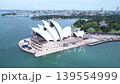 Drone footage of the Sydney Opera House against a blue sky. 139554999