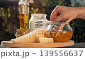 Rustic Greek scene captures air travel for food lovers, presenting local cheese, honey, and olives as symbols of regional farm heritage. 139556637