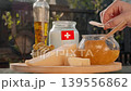 Rustic Swiss scene captures air travel for food lovers, presenting local cheese, honey, and dairy products as symbols of regional farm heritage. 139556862
