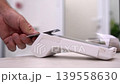Close up of customer hand making a contactless credit card payment on a white POS terminal in a professional medical clinic or office 139558630