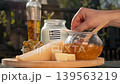 Rustic Greek scene captures air travel for food lovers, presenting local cheese, honey, and olives as symbols of regional farm heritage. 139563219