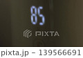 Digital thermometer displaying increasing temperature readings of 86, 92, and 99 degrees Fahrenheit in a close-up view, showcasing temperature progression 139566691