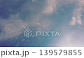 Serene Blue Sky with Soft White Clouds.A peaceful view of a bright blue sky filled with wispy, ethereal white clouds. Perfect for nature backgrounds and tranquil concepts. 139579855