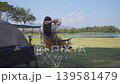 asian woman fun happy and relax with camping and picnic at side of lake with mountain background 139581479