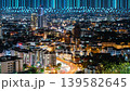 Stunning urban skyline at night with vibrant lights and a digital overlay that symbolizes technology and innovation, offering a glimpse into a connected future. 139582645