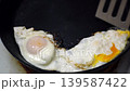 making fried eggs for breakfast 139587422