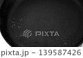 Place the frying pan on a hot electric stove. 139587426