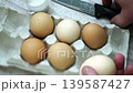 takes a few eggs from the package 139587427