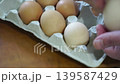 takes a few eggs from the package 139587429