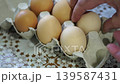takes a few eggs from the package 139587431