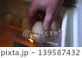 We open the refrigerator and take the eggs. 139587432