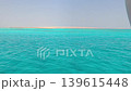A view of the island, coral reef, and sandbar on a sunny, clear day at sea. An active lifestyle during vacations, holidays, and weekends. A boundless ocean of nature. 139615448