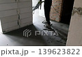 Floor screed. A man polishing the floor after screeding. A video of a man with a polishing machine for the concrete floor. 139623822