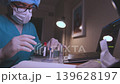 Medical researcher analyzing test tube samples using laptop 139628197