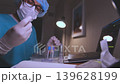 Laboratory scientist carefully analyzing blood sample test tube 139628199
