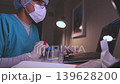 Male scientist in laboratory analyzing blood samples on laptop 139628200