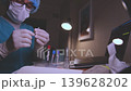 Laboratory scientist preparing syringe and test tubes 139628202