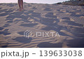 Shadow of Man Walking on Sand Dune at Sunset 139633038