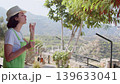 Summer Lifestyle Woman Blowing Bubbles on Terrace 139633041