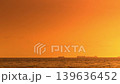 Silhouettes of cargo ships and other vessels floating on the sea at sunset. 139636452