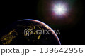 Earth is shown in the foreground, lit by city lights at night, while the sun shines brightly in the background, creating a stunning contrast between light and darkness. 139642956