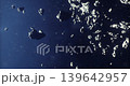 Clusters of asteroids navigate through the blackness of space, showcasing a variety of shapes and sizes. This celestial display highlights the beauty of distant cosmic bodies. 139642957