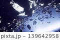 A vast asteroid field in deep space showcases numerous rocky formations and celestial bodies illuminated by distant starlight. The view highlights the dynamic nature of the cosmos. 139642958