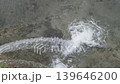 stream of water merges into river, slow motion 139646200