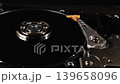 Closeup shot of the inside of a hard drive. Different components. The disk is spinning. Metallic. Technology. Storage. Blurred background. Selective focus. Camera slowly moving around. 139658096
