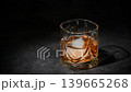 A bartender adding red vermouth into a whiskey glass filled with ice and whiskey. 139665268
