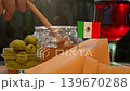 Mexican dairy specialties, honey, and cheese create a cozy regional scene with a glass of red wine and authentic rural character. 139670288