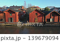 Porvoo.Finland-December 12.2020: Closer drone shot of the old Northern riverside architecture in Porvoo Finland with red wooden houses on a sunny day in autumn 139679094