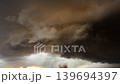 Powerful cumulonimbus clouds building in dark severe weather atmosphere 139694397