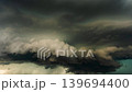 Heavy storm cloud layers shifting through a dramatic overcast sky scene 139694400