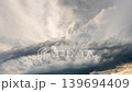 Dark cloud formations moving through the sky during a powerful storm scene 139694409