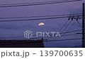 A cityscape and telephone poles at dawn, with the full moon hidden behind clouds (30-second live-action video of a bird crossing the screen, filmed in March 2026) 139700635