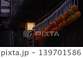 Dried persimmons hanging under the eaves of a rainy Tsumago-juku inn, illuminated by a lantern (Kiso District, Nagano Prefecture - Live-action video) 139701586