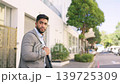Businessman, waiting and crossing street in a city, calm on sidewalk on his commute to work. Looking, entrepreneur and indian male checking for safety traffic before enjoying a morning walk in London 139725309