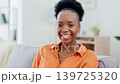 Black woman, face and smile on sofa in home living room with comic laugh, relax or peace in morning, Girl, lounge couch and happiness in portrait in house for me time, freedom or sitting in apartment 139725320