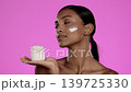 Skincare, face cream and woman with a jar in studio for a beauty, natural and skin routine. Wellness, health and model with facial spf, lotion or moisturiser for cosmetic treatment by pink background 139725330